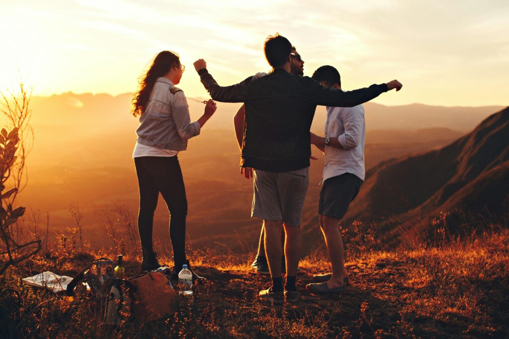 Joyful group of young adults enjoying a sunset view in a mountainous landscape in Brazil. Instagram